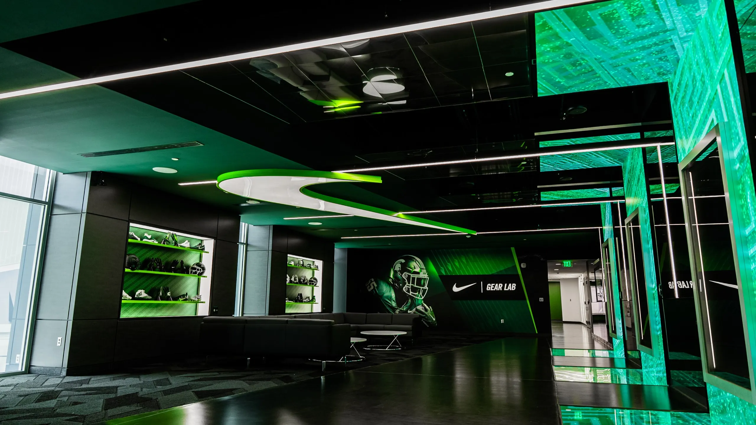 uturistic Nike Gear Lab interior with green lighting, sleek furniture, and sports gear displays.